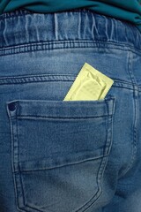 Wrapped condom in the back pocket of pants.Protection against unwanted conception and sexually...