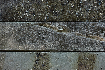 Close-up texture of a gray decorative scratched brick with a gap
