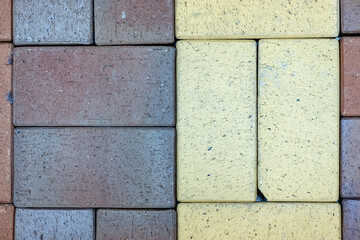 Close-up texture of a gray and yellow scratched paving slabs