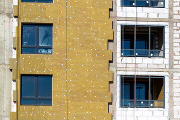 Installation of external wall thermal insulation with rock wool. Exterior passive house wall heat...
