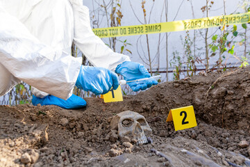 Forensic science specialist working on human remains identification. Taking DNA evidence with a...