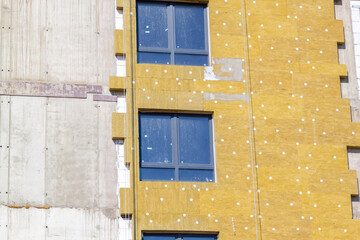 Installation of external wall thermal insulation with rock wool. Exterior passive house wall heat...