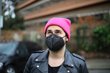 Portrait of a man in the city wearing protective face mask. Outdoor.