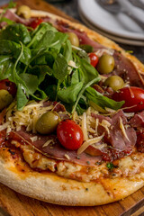 homemade pizza with tomato and arugula