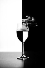 a glass of water and smoke on a black and white background