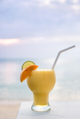 Cocktails or juice from fresh tropical fruits on the background of the sea.