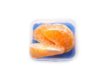 School lunch box snack for kids over white background. Back to school. Healthy and fun snack option for parents. Bow with orange.