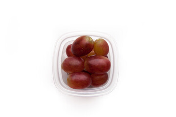 School lunch box snack for kids over white background. Back to school. Healthy and fun snack option for parents. Bow with grapes.