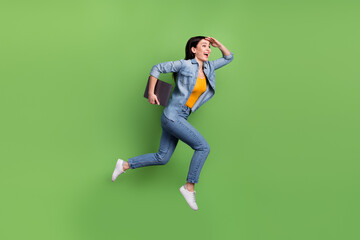 Full body profile photo of funny brown hairdo lady run look wear jeans shirt isolated on pastel green color background