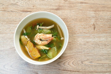 boiled mixed vegetable topping shrimp Thai spicy soup on bowl