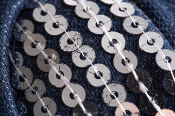 Fashionable sequins on clothes, close-up. Silver shiny jewelry