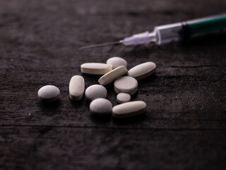 Syringe with medicine pill on textured background stock image.