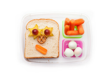 Fototapeta na wymiar School lunch box snacks for kids over white background. Back to school. Healthy and fun snacks option for parents. Cute food art creative concepts. Bows with fruits and vegetables and cute sandwich.