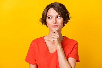 Portrait of nice brunette optimistic lady look empty space wear red t-shirt isolated on vivid yellow color background