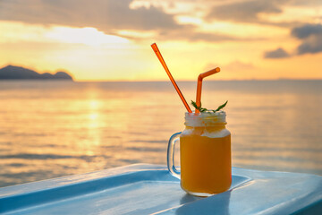 Cocktails or juice from fresh tropical fruits on the background of the sea.
