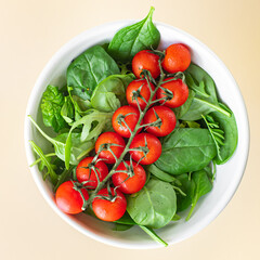 tomato salad cherry veggie green leaves fresh mix greens spinach, arugula, lettuce ingredient on the table healthy food meal copy space food background keto or paleo diet  