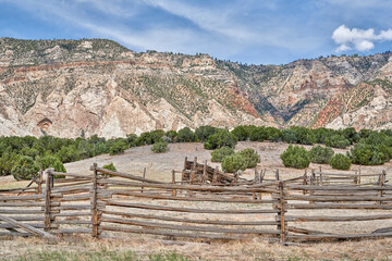 cattle corral in arid landscape of north western Colorado with prominent Cliff Ridge near Dinosaur National Monument