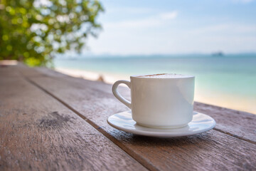 White cup of coffee on wooden tabletop
