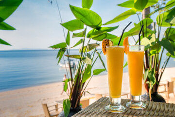 Cocktails or juice from fresh tropical fruits on the background of the sea.
