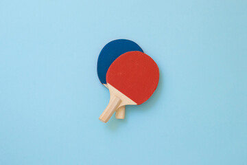 Wooden pinpong rackets with red and blue color on light colored background