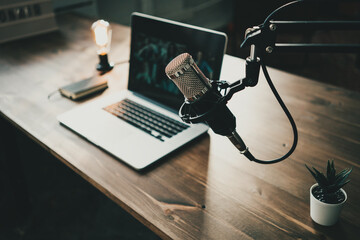 Home studio podcast interior. Microphone, laptop and on air lamp on the table - obrazy, fototapety, plakaty