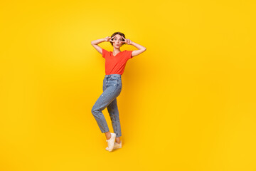 Fototapeta na wymiar Full body portrait of nice young girl two hands fingers show v-sign near eyes isolated on yellow color background
