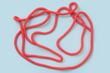 Pink sports rope on blue background