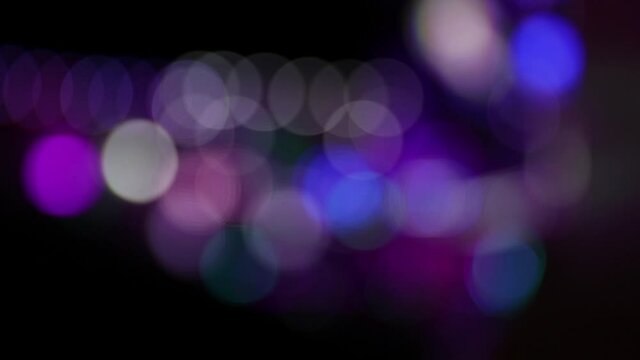 Blurry blinking lights of a carnival fairground at night