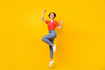 Full length photo of astonished pretty lady fists up open mouth shout yes isolated on yellow color background