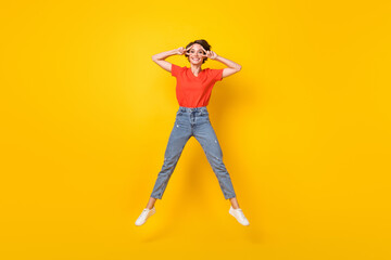 Fototapeta na wymiar Full body photo of cheerful charming girl fingers show v-sign near eyes toothy smile isolated on yellow color background