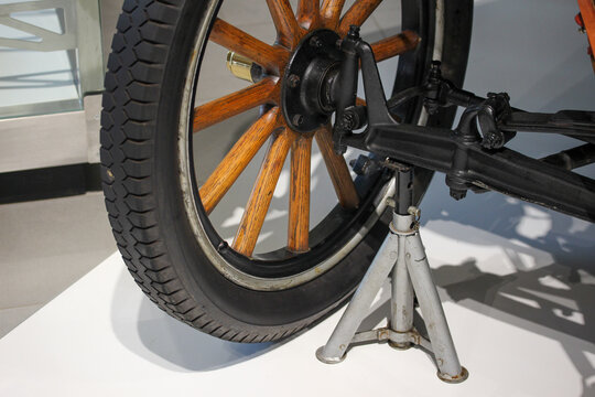Antique car wheel on an axle stand