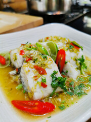 steamed fish spicy lime sauce. sour and spicy fish dish. very popular Thai food