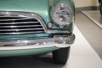 Green classic sports car headlight