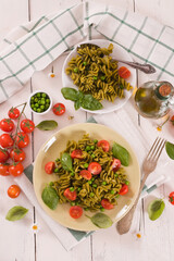 Fusilli pasta with cherry tomatoes and peas.