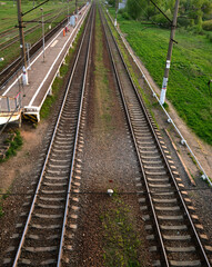 Fototapeta na wymiar Two parallel railways going behind the horizont