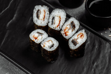 Simple maki with tuna. Sushi on a gray background