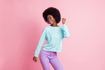 Photo portrait of girl dancing at party wearing blue shirt smiling happy isolated on pastel pink color background