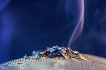 Spices for smoking in the studio photographed with smoke and dark background