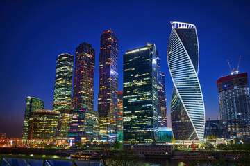 Skyscrapers of Moscow City business center in Moscow in evening, Russia. Illuminated downdtown of the city. Architecture and landmark of Moscow