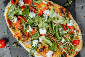 vegetarian pizza with cheese tomatoes and greens