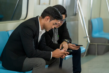 Fototapeta na wymiar Passenger using social network via smart mobile phone in subway train,People in the train travel during rush hours.