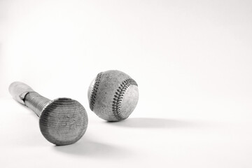 Close up of old baseball wooden bat with used ball isolated on retro white background for sport.