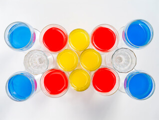 Background of glasses with colored liquid viewed from above 