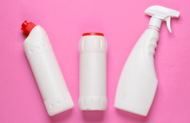 Bottles of cleaning product on pink background. Top view. Cleaning concept. Minimalism