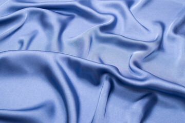 Blue silk or satin luxury fabric texture. Top view.