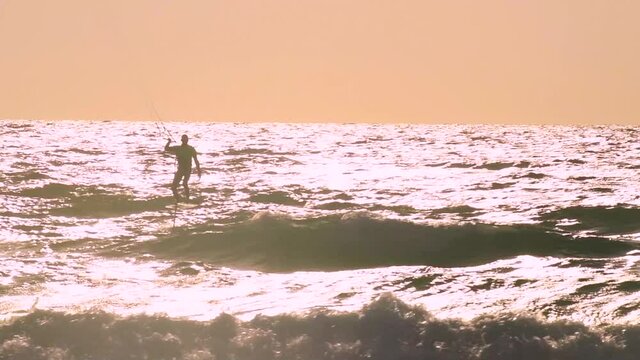 Slow motion of foil kitesurfing at sunset