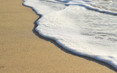 Foam of wave on beach sand, Cornwall