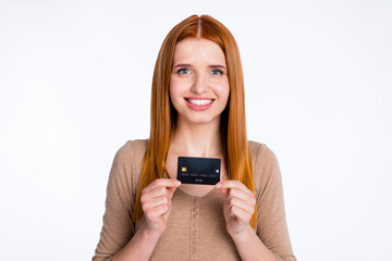 Photo of charming adorable ginger lady wear beige shirt smiling holding credit card isolated white color background