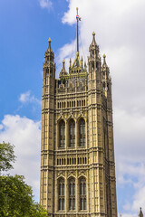 Fototapeta na wymiar Victoria Tower - largest and tallest (98 m) tower of Palace of Westminster. Palace of Westminster (or Houses of Parliament) located in City of Westminster, London.