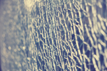 Colorless background of cracks on broken glass, texture